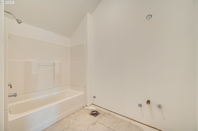 bathroom with shower / bathtub combination and vaulted ceiling