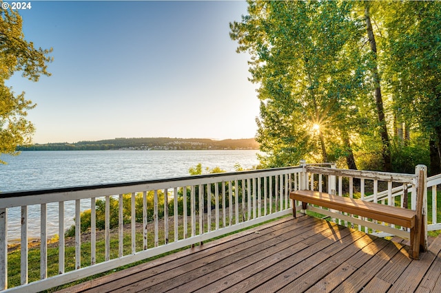 wooden terrace featuring a water view