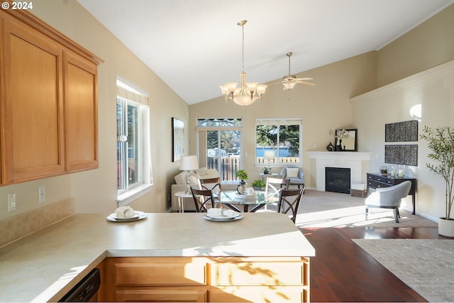 dining room featuring ceiling fan with notable chandelier, dark hardwood / wood-style flooring, a wealth of natural light, and lofted ceiling