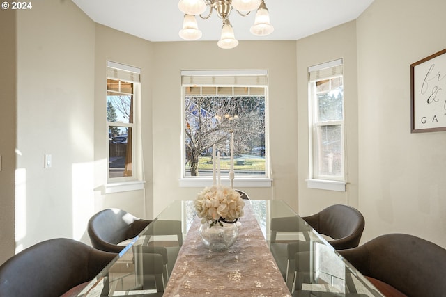 dining area featuring an inviting chandelier and a healthy amount of sunlight