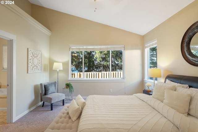 carpeted bedroom featuring vaulted ceiling and multiple windows