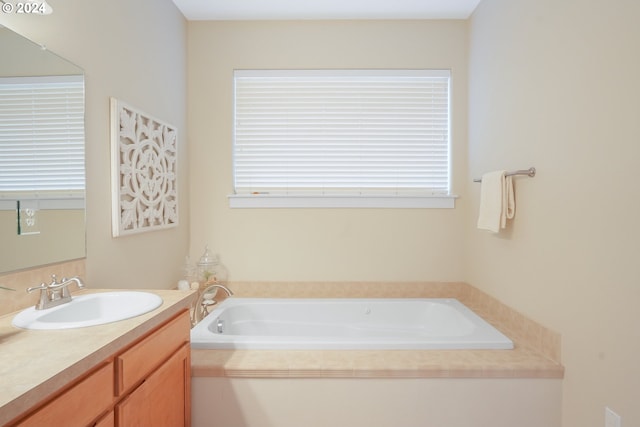 bathroom featuring vanity and a tub to relax in