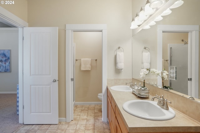 bathroom with an enclosed shower, vanity, and toilet