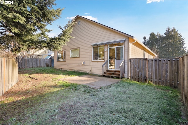 back of property featuring a yard and a patio