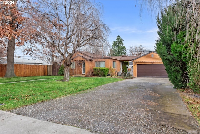 ranch-style home with a garage and a front yard