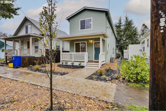 view of front of home with a porch and central air condition unit