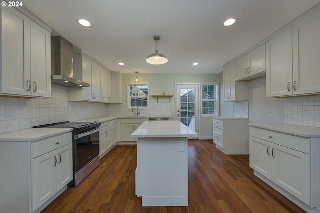 kitchen featuring stainless steel range with electric stovetop, dark hardwood / wood-style floors, white cabinetry, and wall chimney range hood