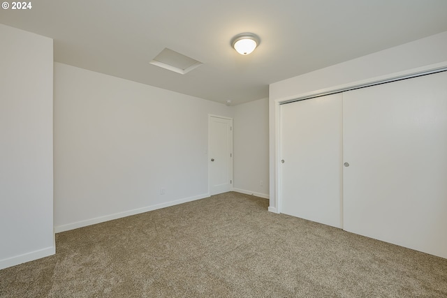 unfurnished bedroom with a closet and carpet