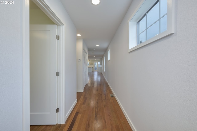 corridor with dark wood-type flooring