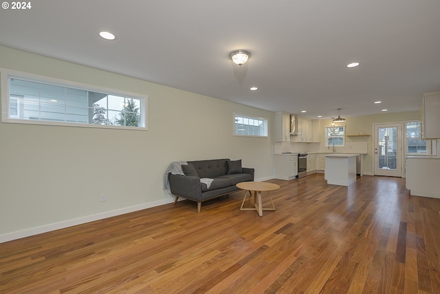 living area with hardwood / wood-style flooring and plenty of natural light