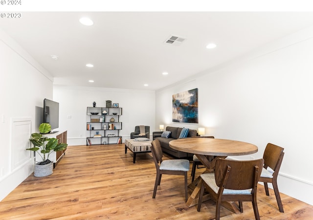 dining room featuring crown molding and light wood-type flooring