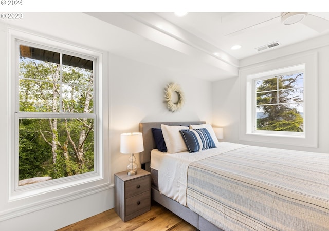 bedroom featuring light hardwood / wood-style flooring and multiple windows