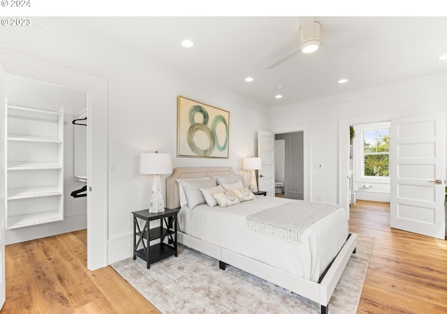 bedroom with ceiling fan and light hardwood / wood-style floors