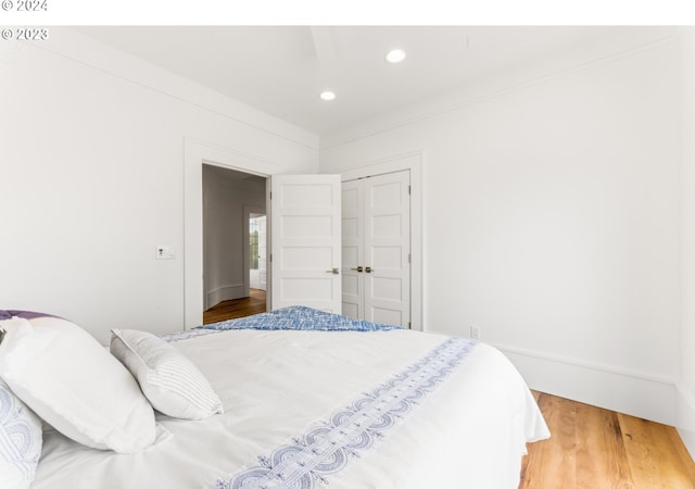 bedroom with a closet and hardwood / wood-style floors