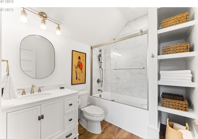 full bathroom with vaulted ceiling, toilet, enclosed tub / shower combo, vanity, and hardwood / wood-style flooring