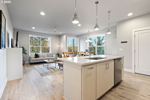 kitchen with sink, decorative light fixtures, a center island with sink, light hardwood / wood-style flooring, and dishwasher