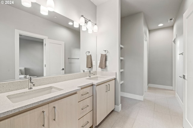 bathroom with tile patterned flooring and vanity