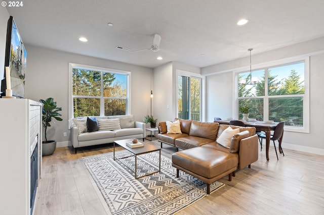 living room featuring recessed lighting, light wood-style floors, visible vents, and baseboards