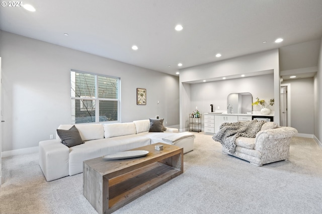 carpeted living room with sink