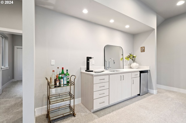 bar featuring dishwasher, sink, and light carpet