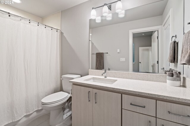 bathroom with tile patterned floors, vanity, and toilet