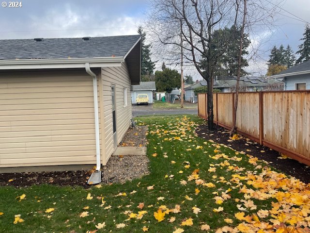 view of side of property with a yard