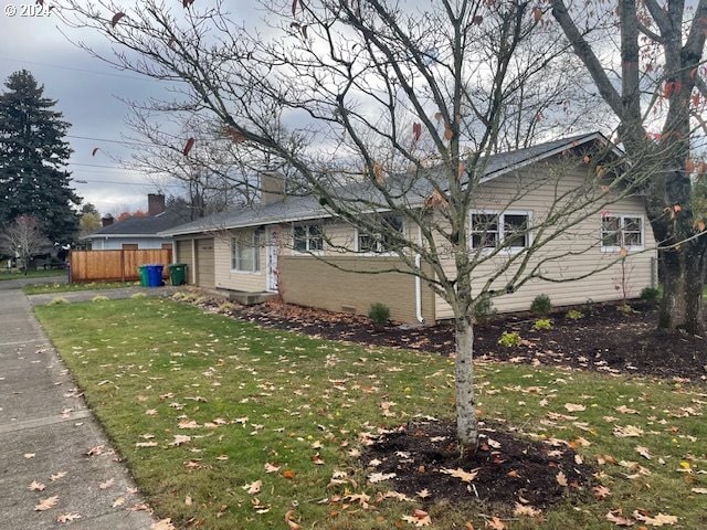 view of side of property with a lawn