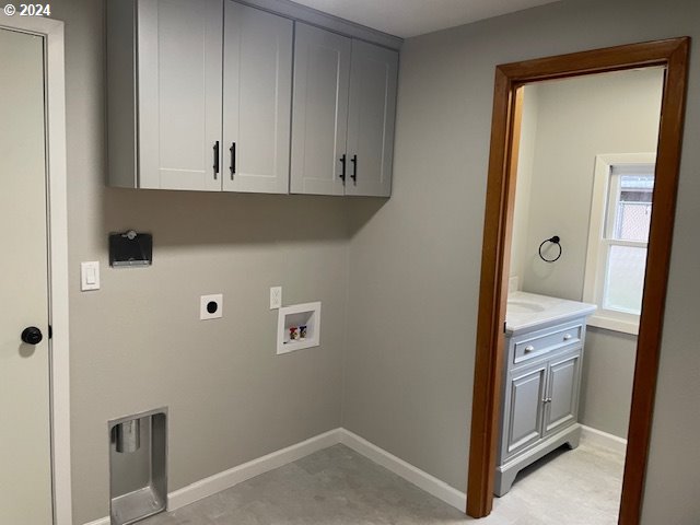 washroom featuring cabinets, hookup for a washing machine, and electric dryer hookup