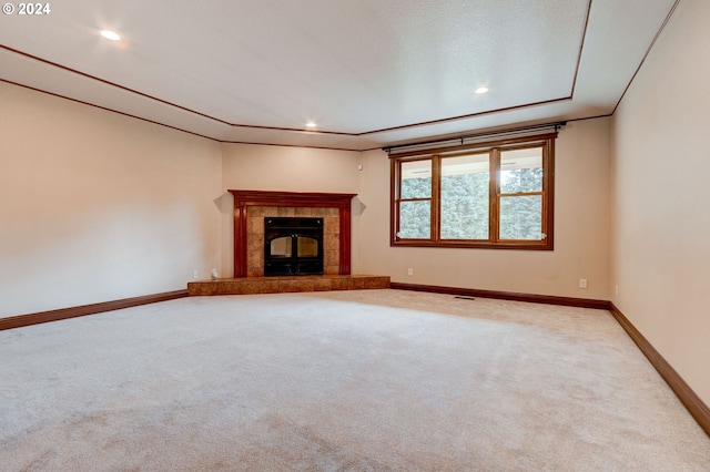 unfurnished living room featuring a textured ceiling, carpet floors, and a fireplace