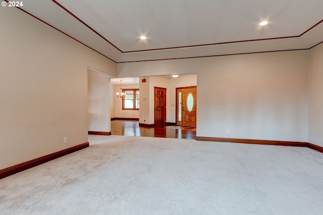 unfurnished room featuring wood-type flooring and a chandelier