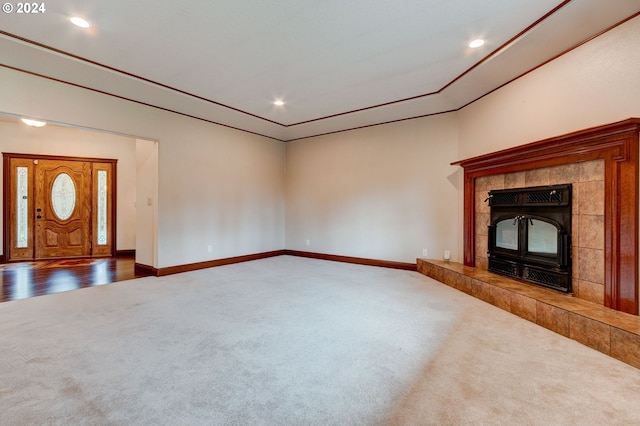 unfurnished living room with a tile fireplace and dark hardwood / wood-style floors