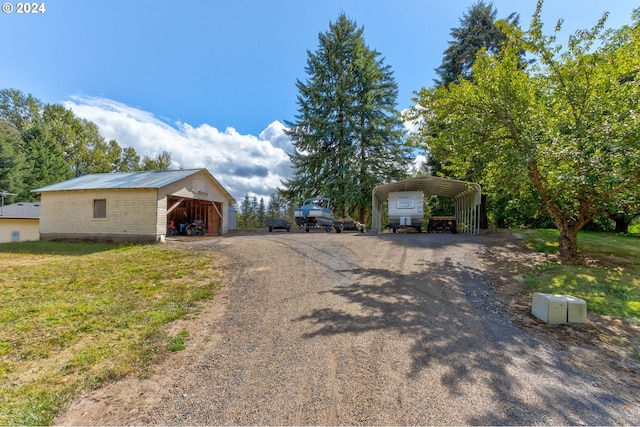 view of front facade featuring a front lawn and a carport