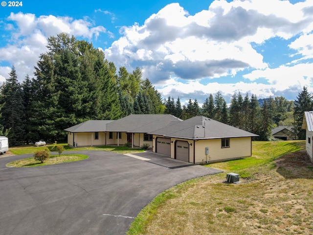 single story home featuring a garage and a front lawn