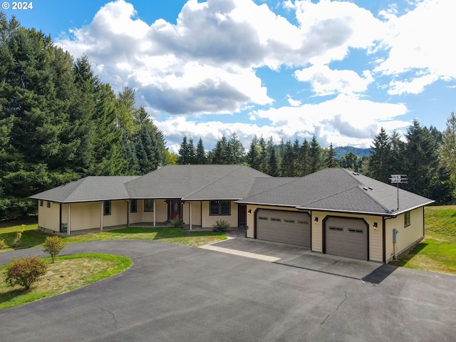 ranch-style home with a garage and a front lawn