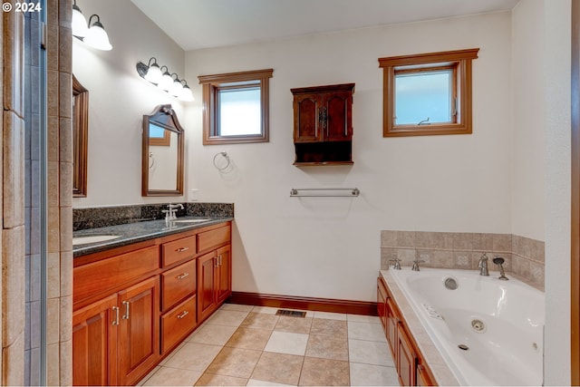 bathroom featuring vanity, a tub, and tile patterned flooring