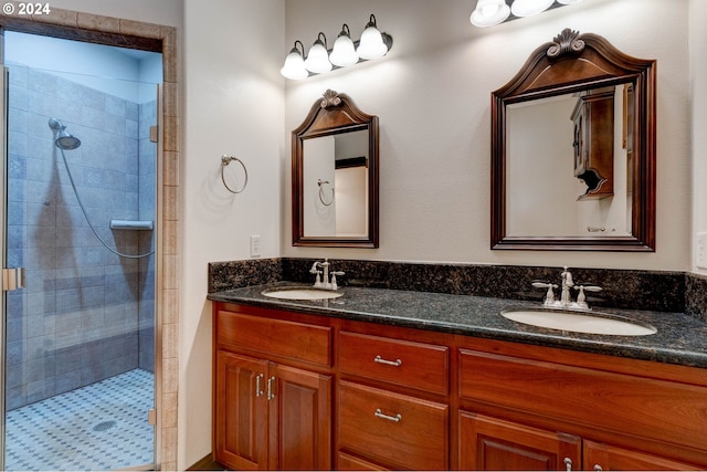 bathroom featuring a tile shower and vanity