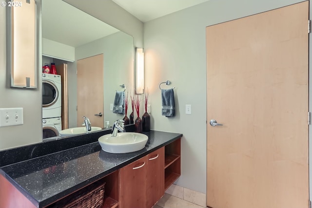 bathroom with vanity, tile patterned floors, and stacked washer / dryer