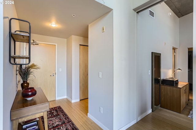 hallway with light hardwood / wood-style flooring