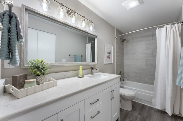 full bathroom with hardwood / wood-style floors, vanity, toilet, and shower / bathtub combination with curtain