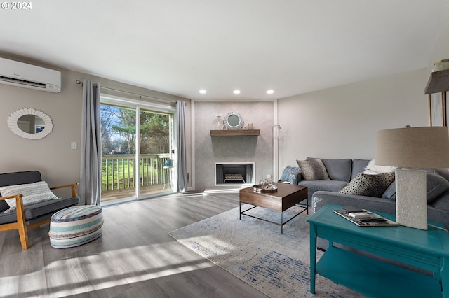 living room with a wall mounted AC and hardwood / wood-style flooring