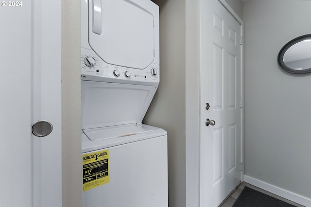 clothes washing area featuring stacked washer / drying machine