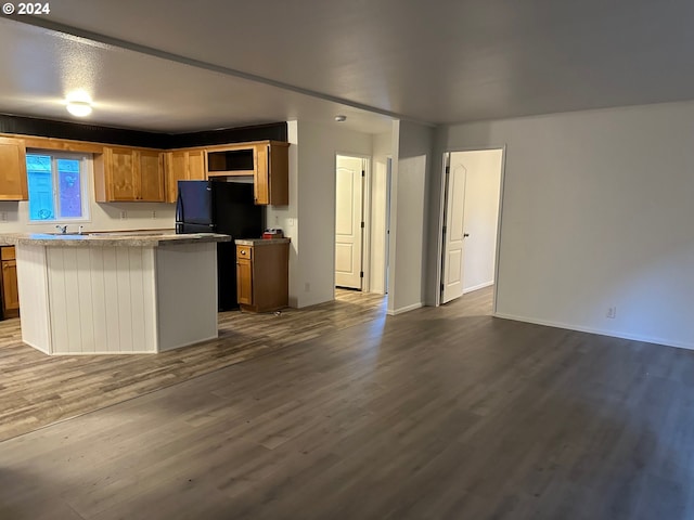 kitchen with dark wood-type flooring and a kitchen island