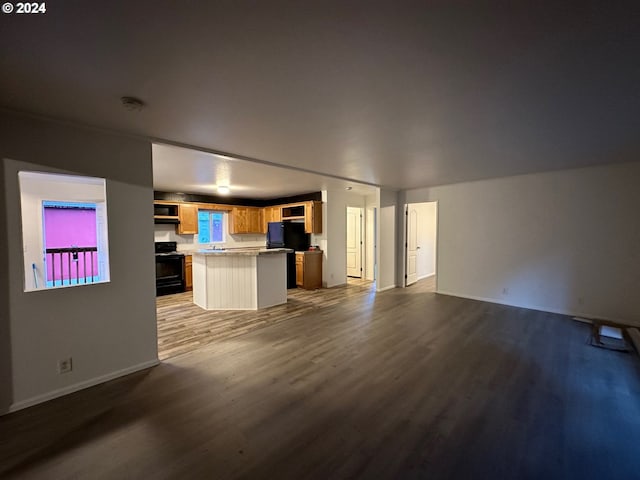 unfurnished living room featuring wood-type flooring