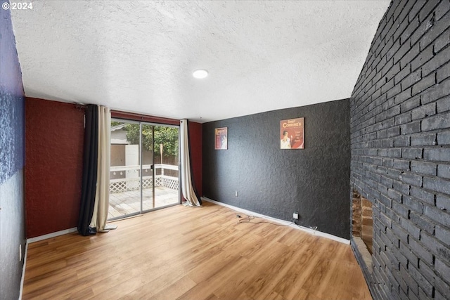 spare room with wood-type flooring and a textured ceiling