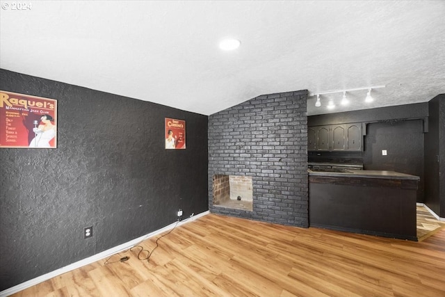 interior space with vaulted ceiling and hardwood / wood-style flooring