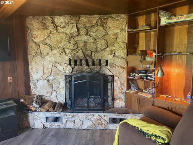 living room with hardwood / wood-style floors, wood ceiling, and wood walls