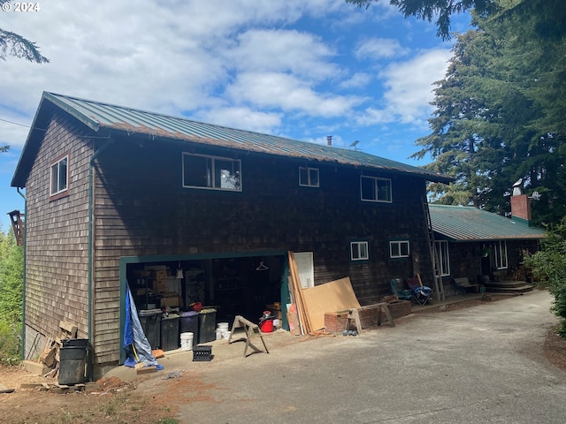 rear view of property with a garage