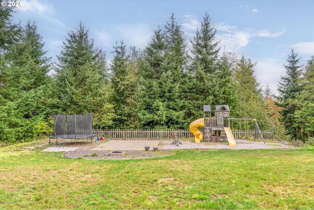 view of yard featuring a playground, a trampoline, and a patio