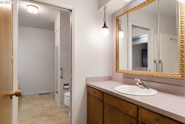 bathroom featuring tile patterned floors, vanity, and toilet