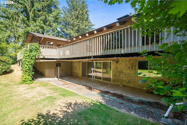 back of property featuring a yard and a balcony